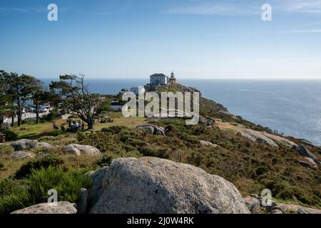 Cape finisterre landmark lighthouse with tourists on a sunny day in Galicia, Spain Stock Photo