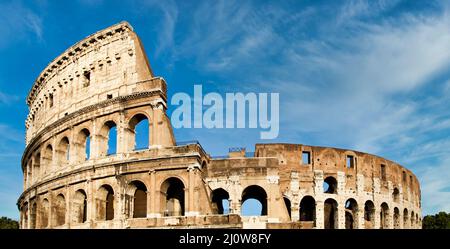 Rome, Italy. Arches archictecture of Colosseum exterior with blue sky background and clouds. Stock Photo