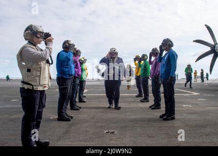 Ionian Sea, Greece. 17 March, 2022. U.S. Secretary of the Navy Carlos Del Toro salutes as he makes way past the sideboys after arriving aboard the aircraft carrier USS Harry S. Truman, March 17, 2022 in the Ionian Sea.  Credit: MC2 Kelsey Trinh/US Navy/Alamy Live News Stock Photo