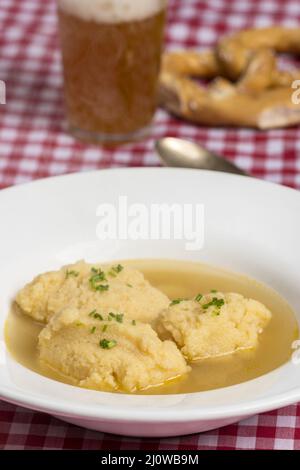 Bavarian semolina gnocchi soup on tablecloth Stock Photo