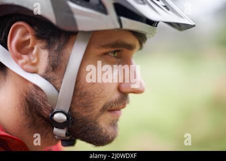 Eye on the prize. Closeup profile of a cyclist wearing a helmet. Stock Photo