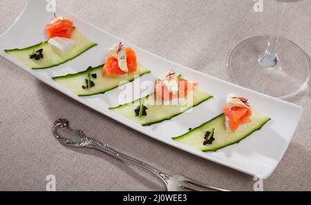 Fresh salad with salmon, two types of cheese and fresh cucumber Stock Photo
