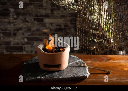 Burning charcoal stove with sparks Stock Photo