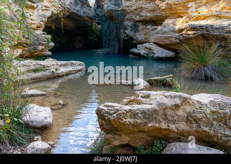 View of the Salto del Usero nature reserve with eroded sandstone cliffs and colorful pools of water Stock Photo