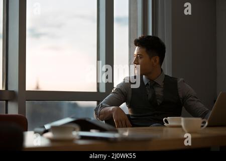 Successful Chinese businessman rests in a conference room Stock Photo