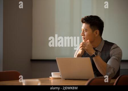 Chinese businessman use laptops for office work Stock Photo