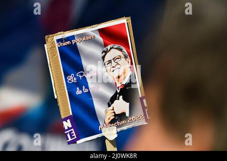 Paris, France. 20th Mar, 2022. Illustration picture shows a person holds up a sign with the portrait of Jean-Luc Melenchon during a major meeting of the far left-wing candidate (La France Insoumise, LFI) after a march for 6th (VIth) Republic from the Bastille to the Place de la Republique three weeks before the first round of the French presidential election, in Paris, France, on March 20, 2022. Photo by Victor Joly/ABACAPRESS.COM Credit: Victor Joly/Alamy Live News Stock Photo