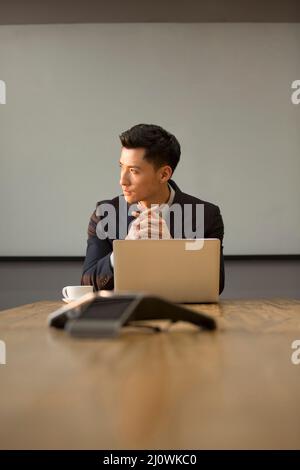 Chinese businessman use laptops for office work Stock Photo