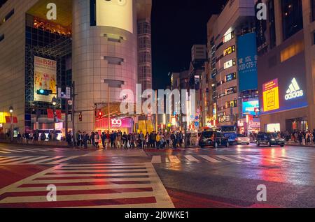 The busy night life in the street of Shibuya shopping district.