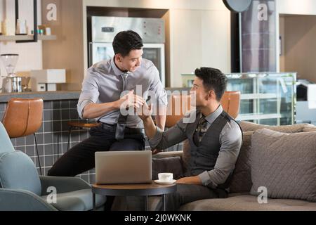 Chinese Businessmen working with laptop in cafe Stock Photo