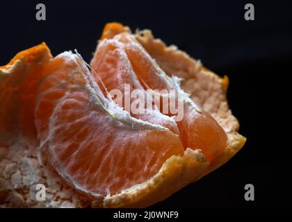 Peeled tangerine on a blue background Stock Photo