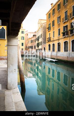 Small canal between houses in Venice Stock Photo