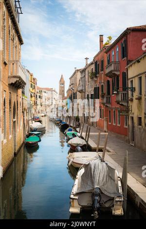 Small canal between houses in Venice Stock Photo