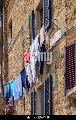 PIENZA, TUSCANY, ITALY - MAY 19 : Washing hanging from building in Pienza Italy on May 19, 2013 Stock Photo