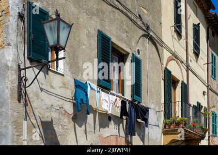 PIENZA, TUSCANY, ITALY - MAY 19 : Washing hanging from building in Pienza Italy on May 19, 2013 Stock Photo
