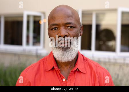 Close-up portrait of bald bearded african american senior man standing outdoors Stock Photo
