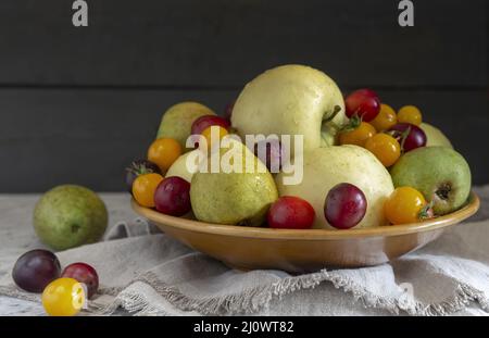 Still life: fruit in a ceramic plate Stock Photo