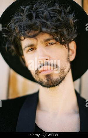 Portrait of a young man in a black hat and jacket Stock Photo