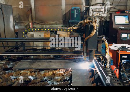 Automatic cnc laser cutting machine working with sheet metal with sparks. Metalworking industrial manufacturing factory Stock Photo