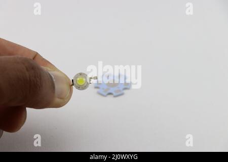 1 Watt LED held in hand with its Heat sink on the background, Powerful 1W white led chip Stock Photo