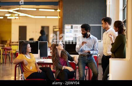 Sharing their views. Shot of colleagues having a discussion in a modern office. Stock Photo