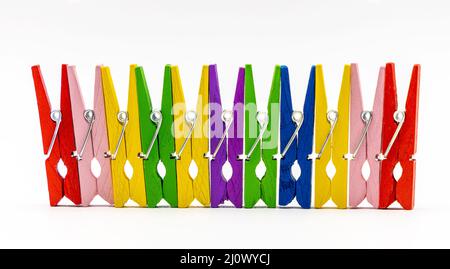 rainbow colorful wooden clothespins on a white background Stock Photo