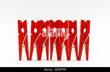 Yellow colorful wooden clothespins on a green background Stock Photo