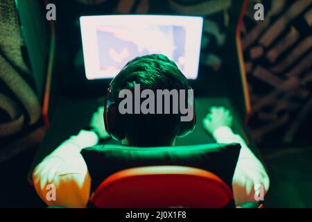 Guy playing gaming game on computer at game club Stock Photo