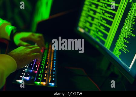 Hacker using computer malware software and hacking binary code digital interface. Stock Photo
