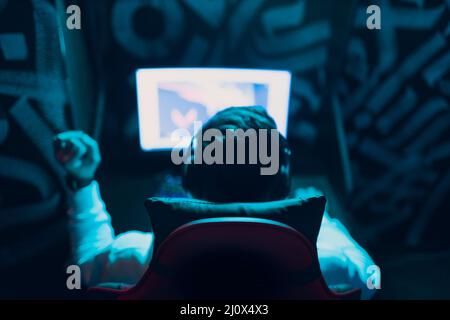 Guy playing gaming game on computer at game club Stock Photo