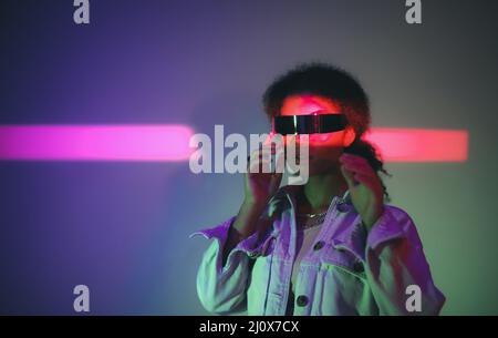 Young confident african american woman in VR headset playing virtual reality games Stock Photo