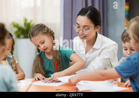 Young teacher helping her students class. High quality photo Stock Photo