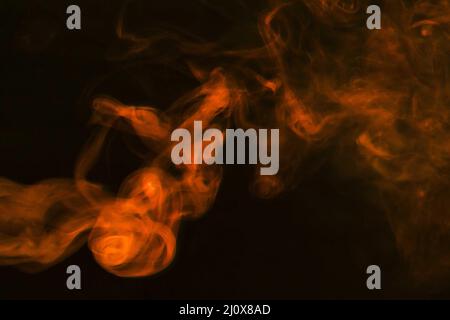 Dense fumes abstract orange smoke dark background. High quality photo Stock Photo