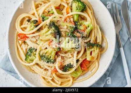 Spaghetti pasta with broccoli, bucatini with peppers, garlic, pine nuts. Food for vegans Stock Photo