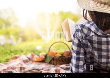 Woman relaxing reading book park. High quality beautiful photo concept Stock Photo