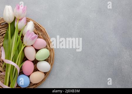 Flat lay multicolored tulips with easter eggs copy space. High quality beautiful photo concept Stock Photo