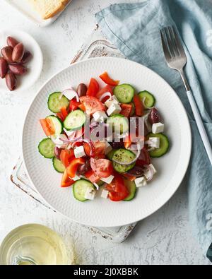 Greek village salad horiatiki with feta cheese, olives, cherry tomato, cucumber and red onion