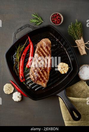 Keto ketogenic diet beef steak, fried striploin on grill pan. Paleo food recipe with meat Stock Photo