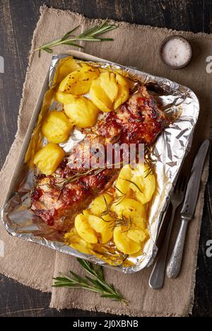 Spicy barbecue pork ribs and crushed smashed potatoes. Slow cooking recipe. Stock Photo