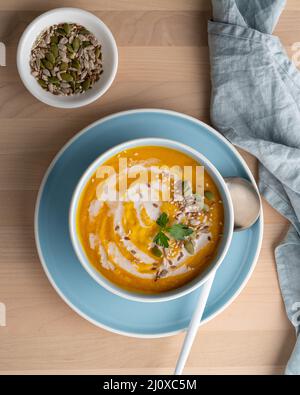 Pumpkin soup with coconut milk, vegetarian dish, healthy diet food, top view, vertical Stock Photo