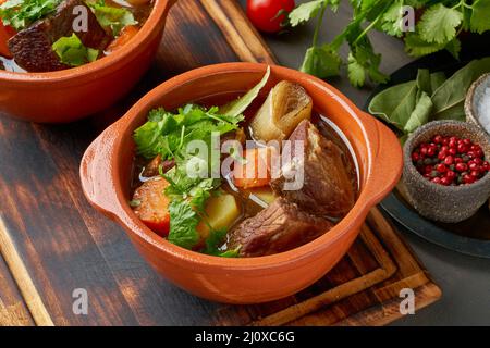 Cooking soup in cast iron boiler on burning campfire. Pot with soup over  the open fire outdoors. Tourism in Latvia. Cooking soup in a pot on  campfire Stock Photo - Alamy