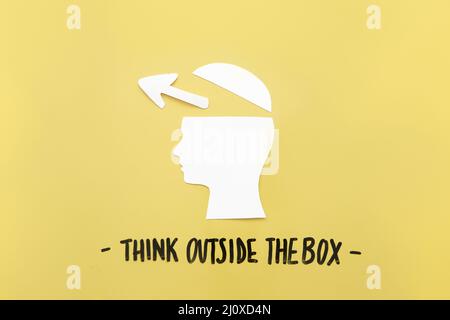 Open human brain with arrow symbol near think outside box message. High quality beautiful photo concept Stock Photo