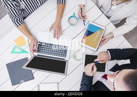 Crop coworkers using modern devices desk Stock Photo