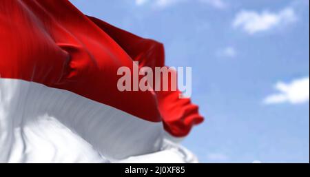 Detail of the national flag of Indonesia waving in the wind on a clear day. Stock Photo