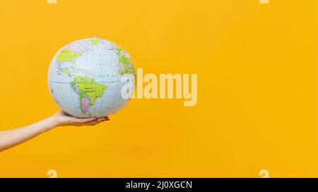 Side view hand holding earth globe with copy space. High quality photo Stock Photo