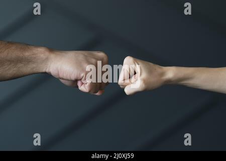 Close up friends ready touch fists Stock Photo
