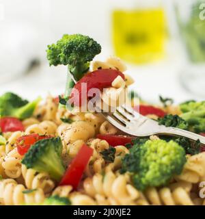 Close up fork with broccoli tomato fusilli. High quality beautiful photo concept Stock Photo