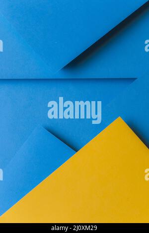 Creative arrangement yellow blue colored paper creating abstract background. High quality beautiful photo concept Stock Photo