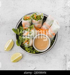 Bowl shrimp rolls with sauce lemon slices Stock Photo