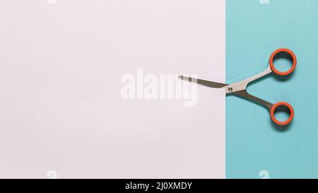 Scissors cutting white paper. High quality photo Stock Photo